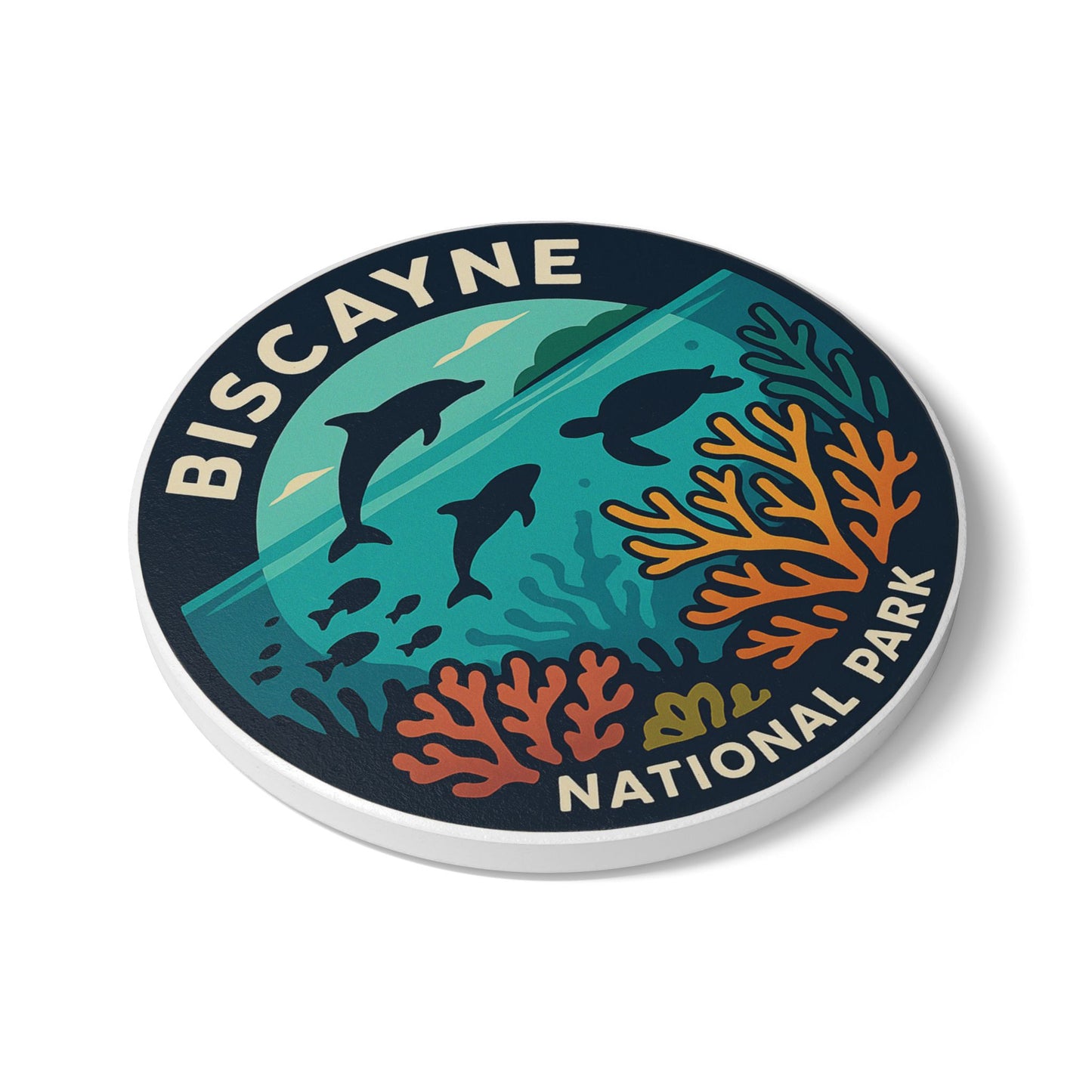 Round coaster with Biscayne National Park design featuring dolphins and coral on a white background