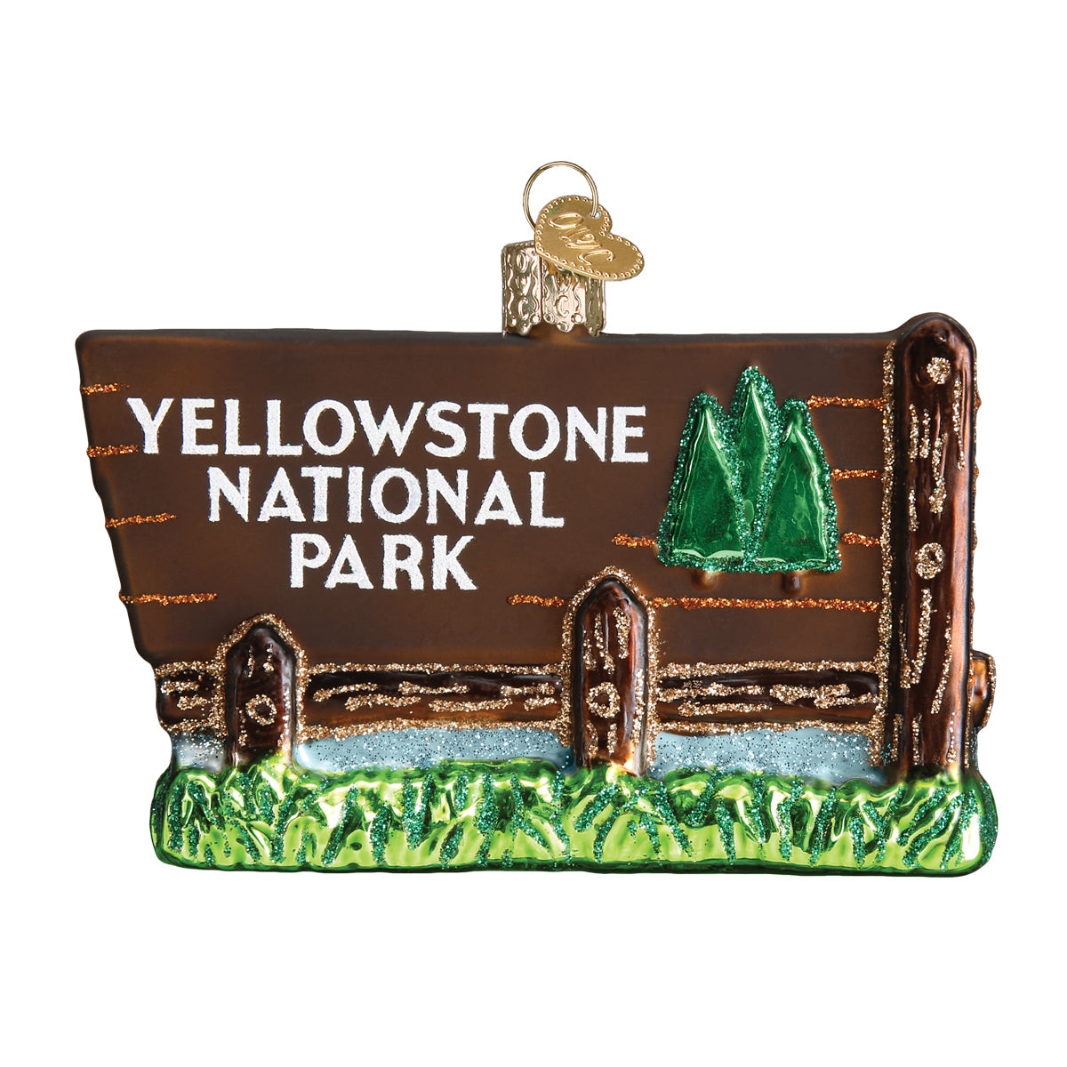 Glass Christmas ornament in shape of the Yellowstone National Park Entrance sign on a white background. 