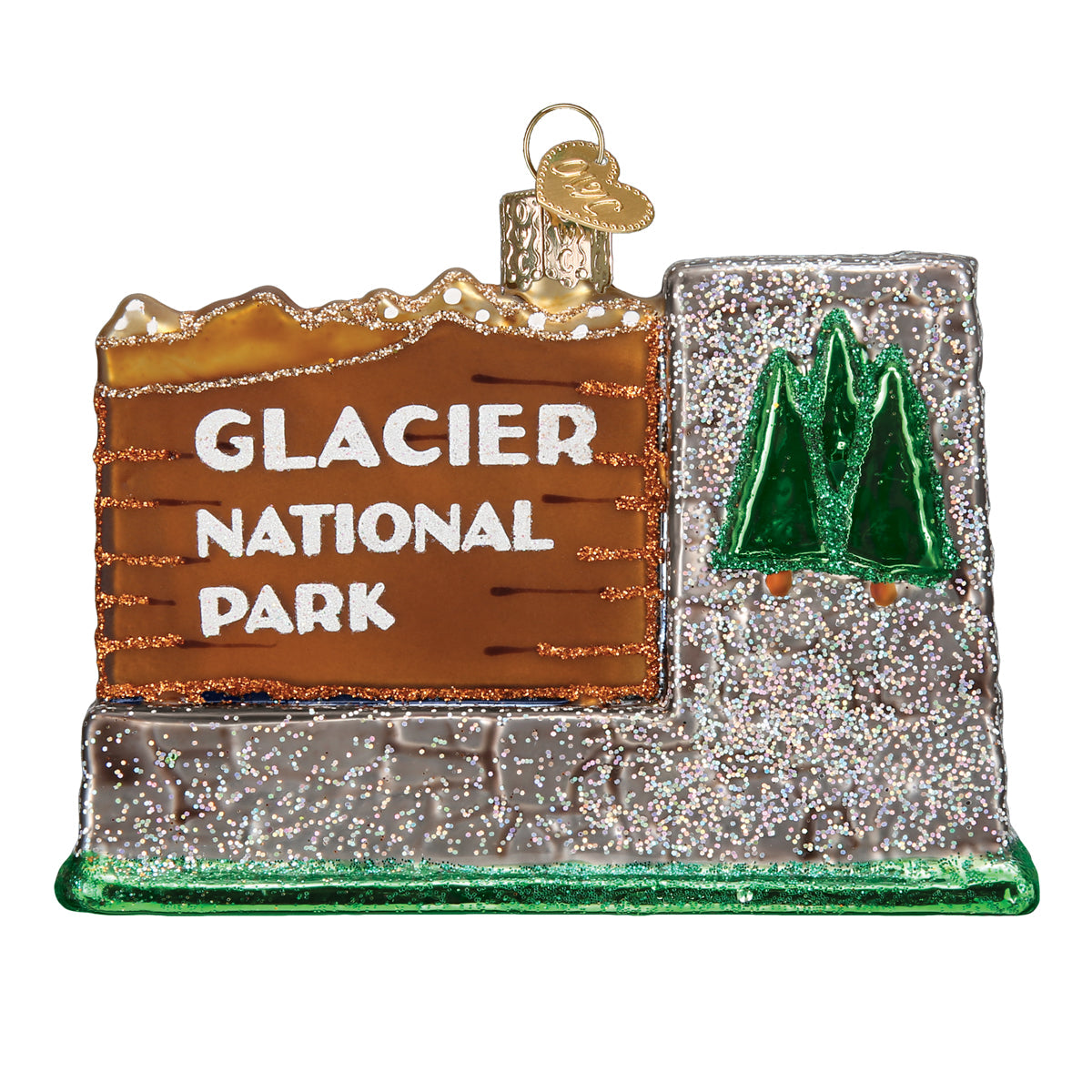 3-D glass ornament in the shape of the glacier national Park entrance sign against a white background