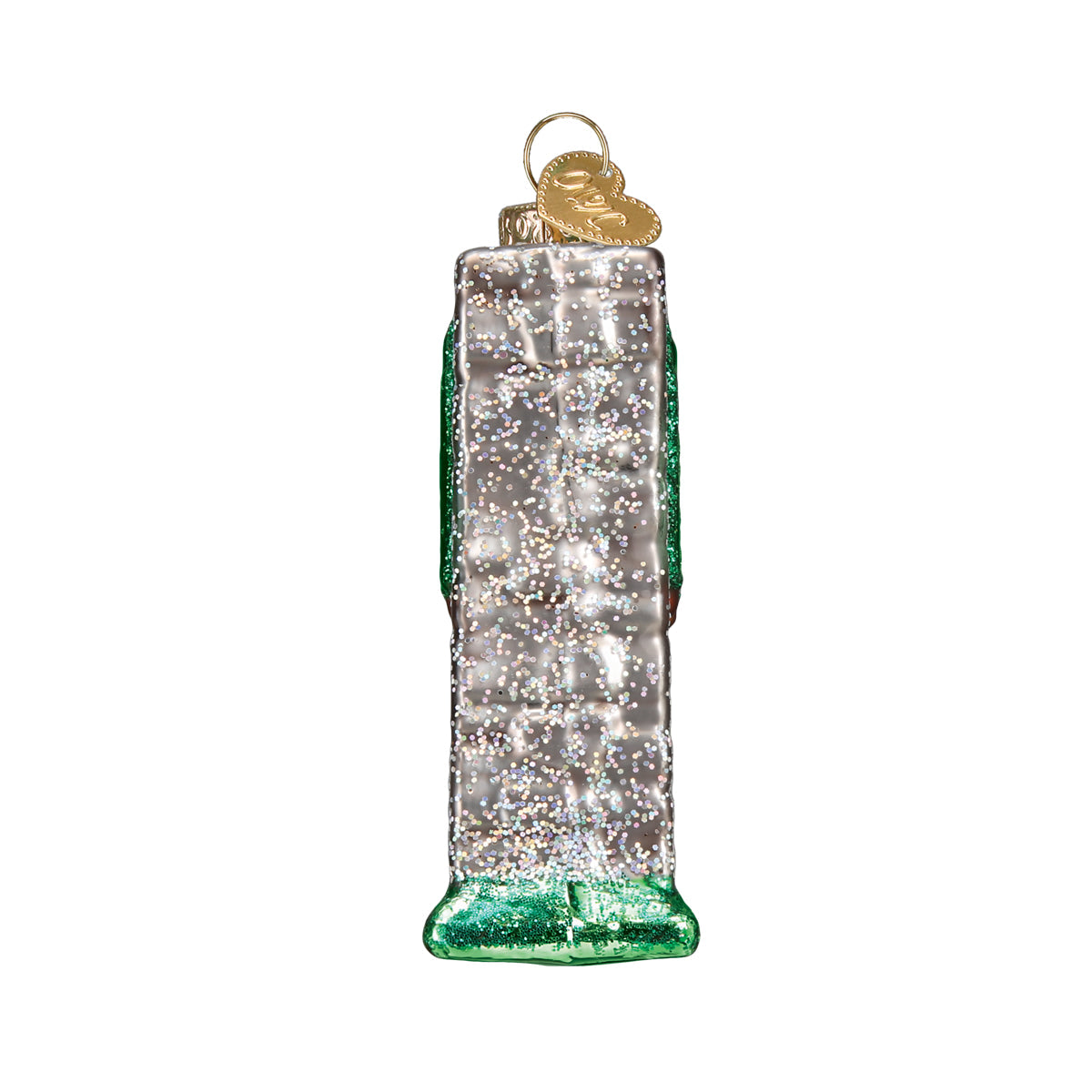 Side view of 3-D glass ornament in the shape of the glacier national Park entrance sign against a white background