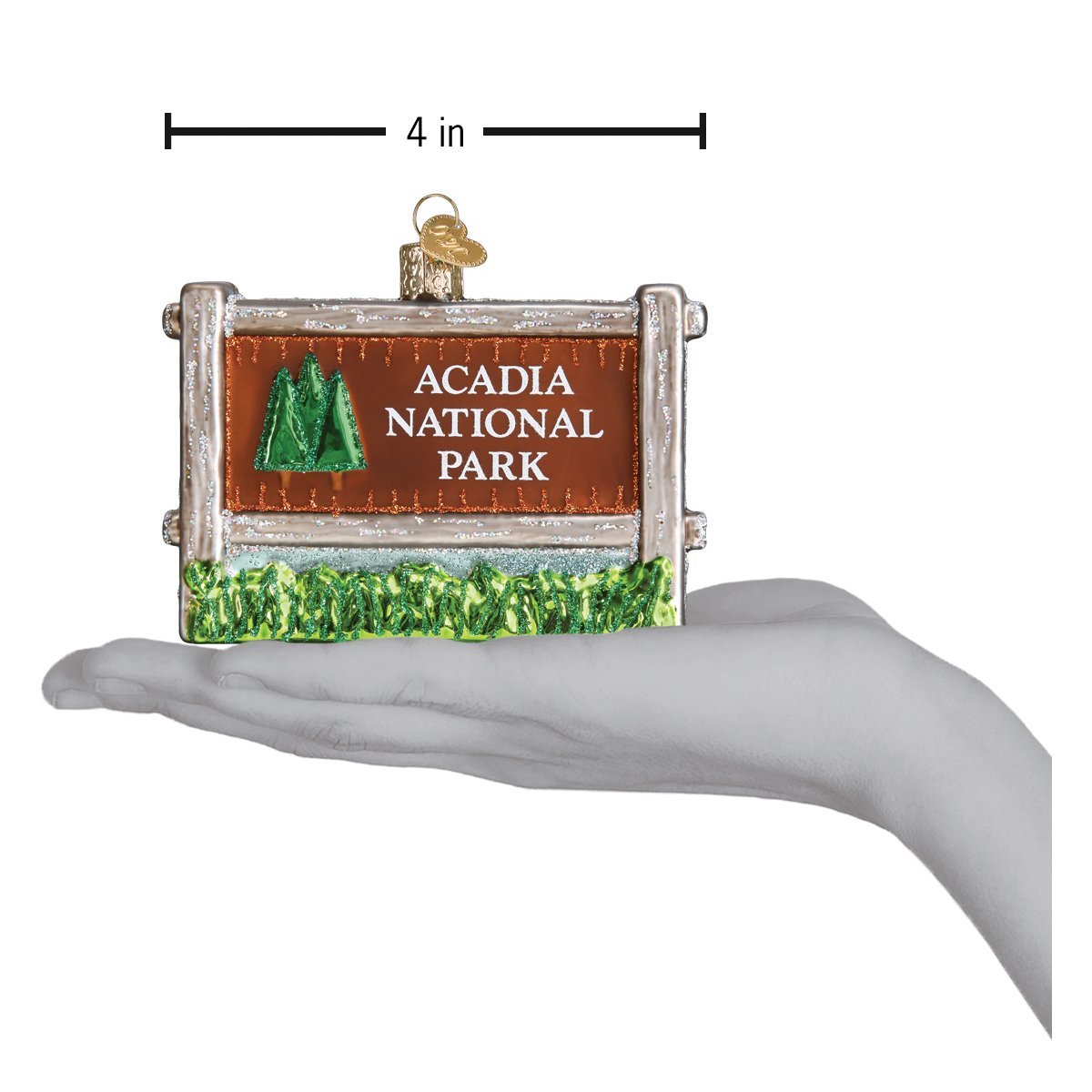 Acadia National Park Glass ornament on a hand depicting size on a white background.