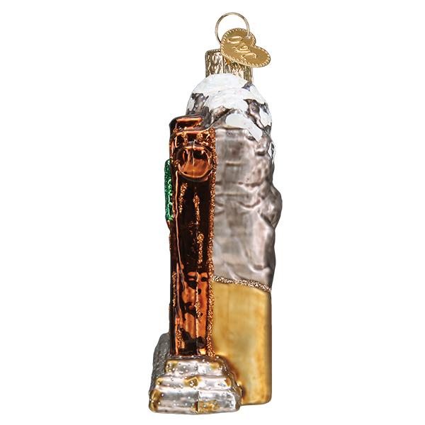 Side view of 3-D glass ornament depicting the entrance sign of grand Teton national Park against a white background