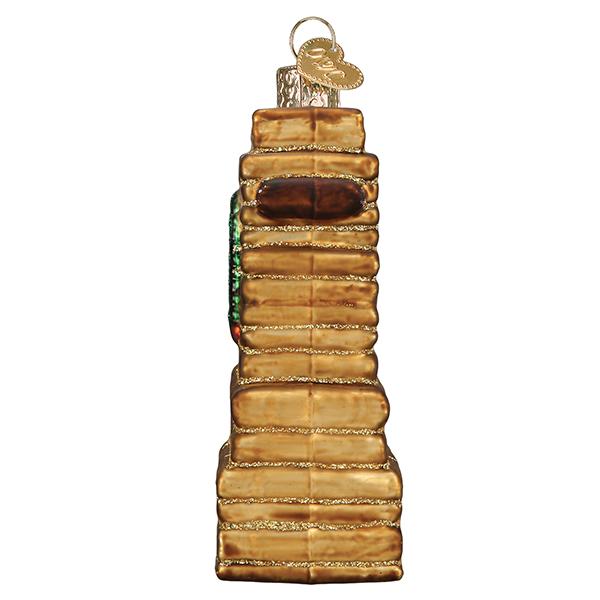 Side view of 3-D glass ornament in the shape of the Zion national park entrance sign on a white background.