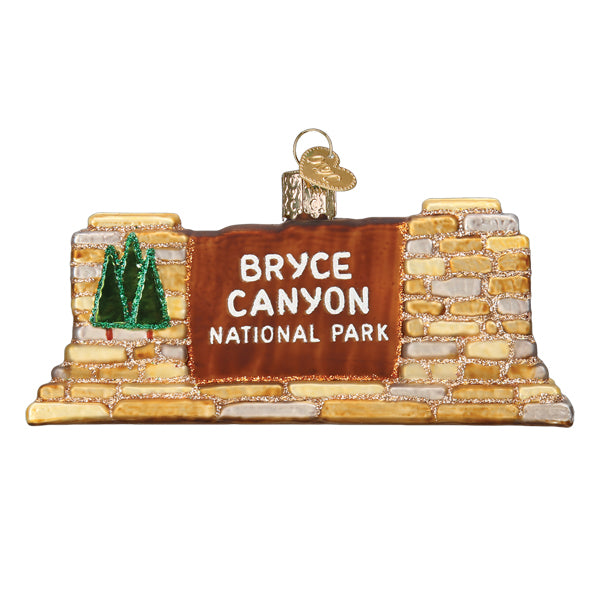 Handcrafted 3-D glass ornament in the shape of the Bryce Canyon national Park entrance sign on a white background.