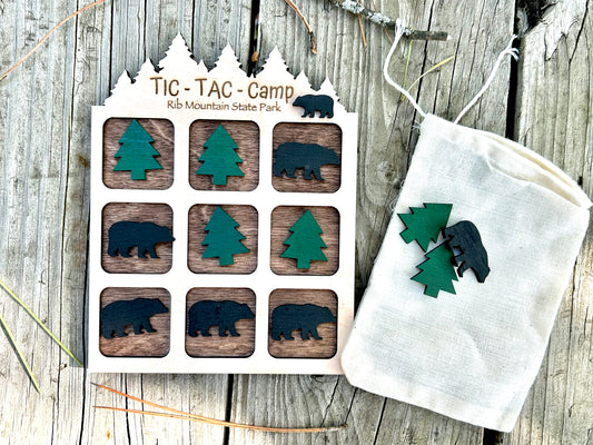 Wood tic-tac-toe board game with bear and tree shaped playing pieces.