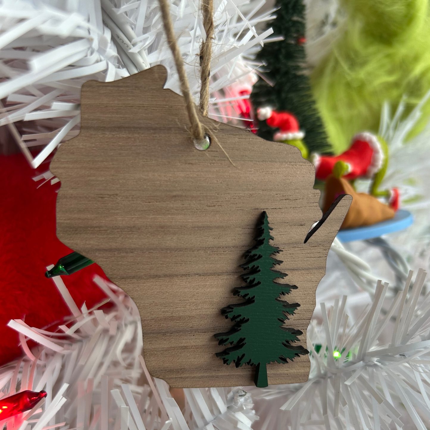 Walnut Wisconsin ornament with a Green tree on Christmas tree background.