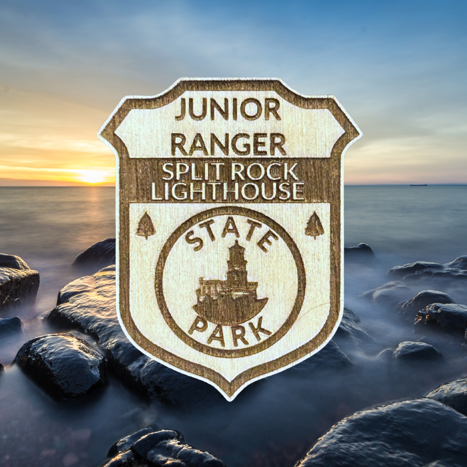 Junior Ranger badge for Split Rock Lighthouse State Park against a scenic background with rocks and water.
