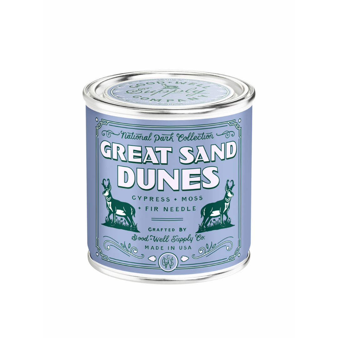Can of 'Great Sand Dunes' candle with decorative label on a white background