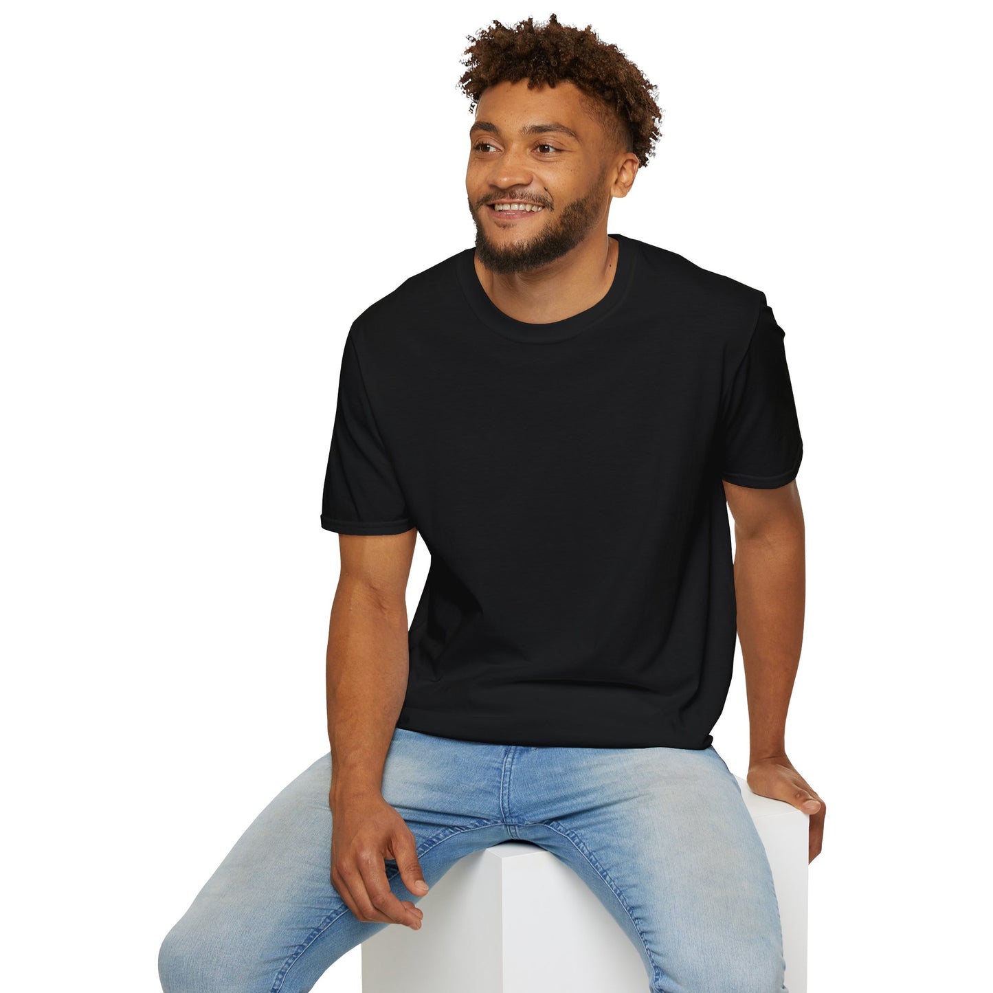 Man wearing a black t-shirt with text sitting on a white stool against a white background