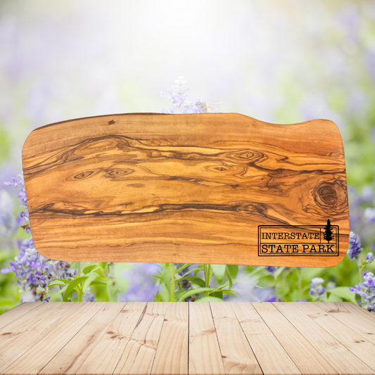 Natural olive wood board with Interstate State Park design engraved on the board.  Photo background: Wood table with lavender flowers.