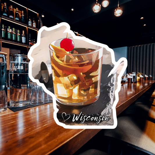 Wisconsin shaped sticker featuring a rendering of an old fashioned drink on a coaster.  Photo background: wood bar counter and drinks.