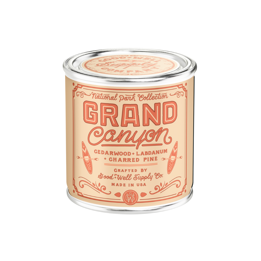 Candle in a clear container with 'Grand Canyon' label on a white background