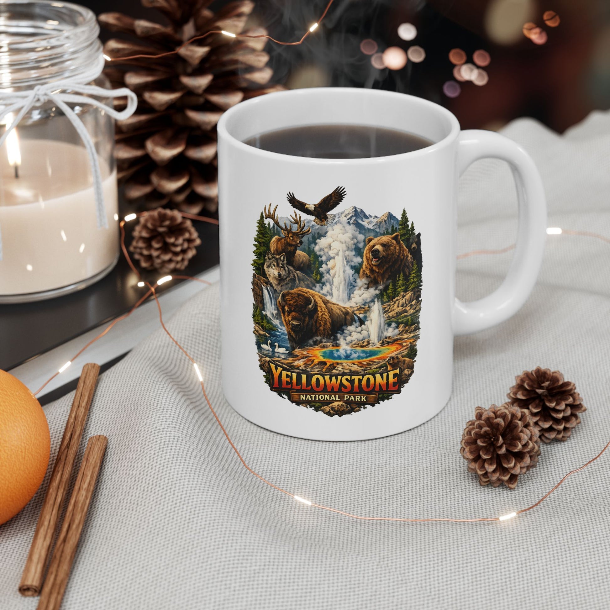 White mug with Yellowstone National Park design on a table with decorative items