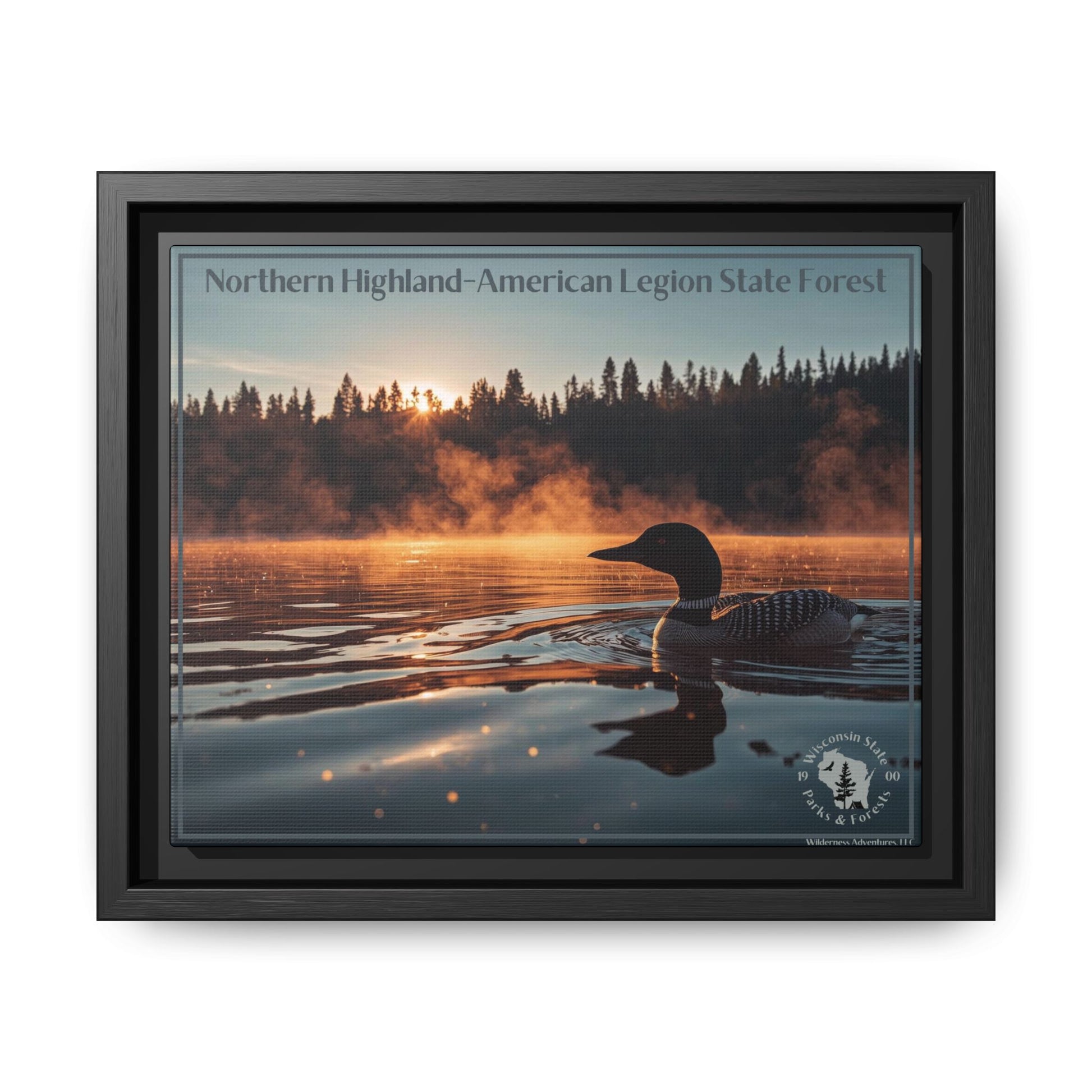 Black framed canvas art depicting a loon swimming on a lake in the early morning as mist rises from the water.