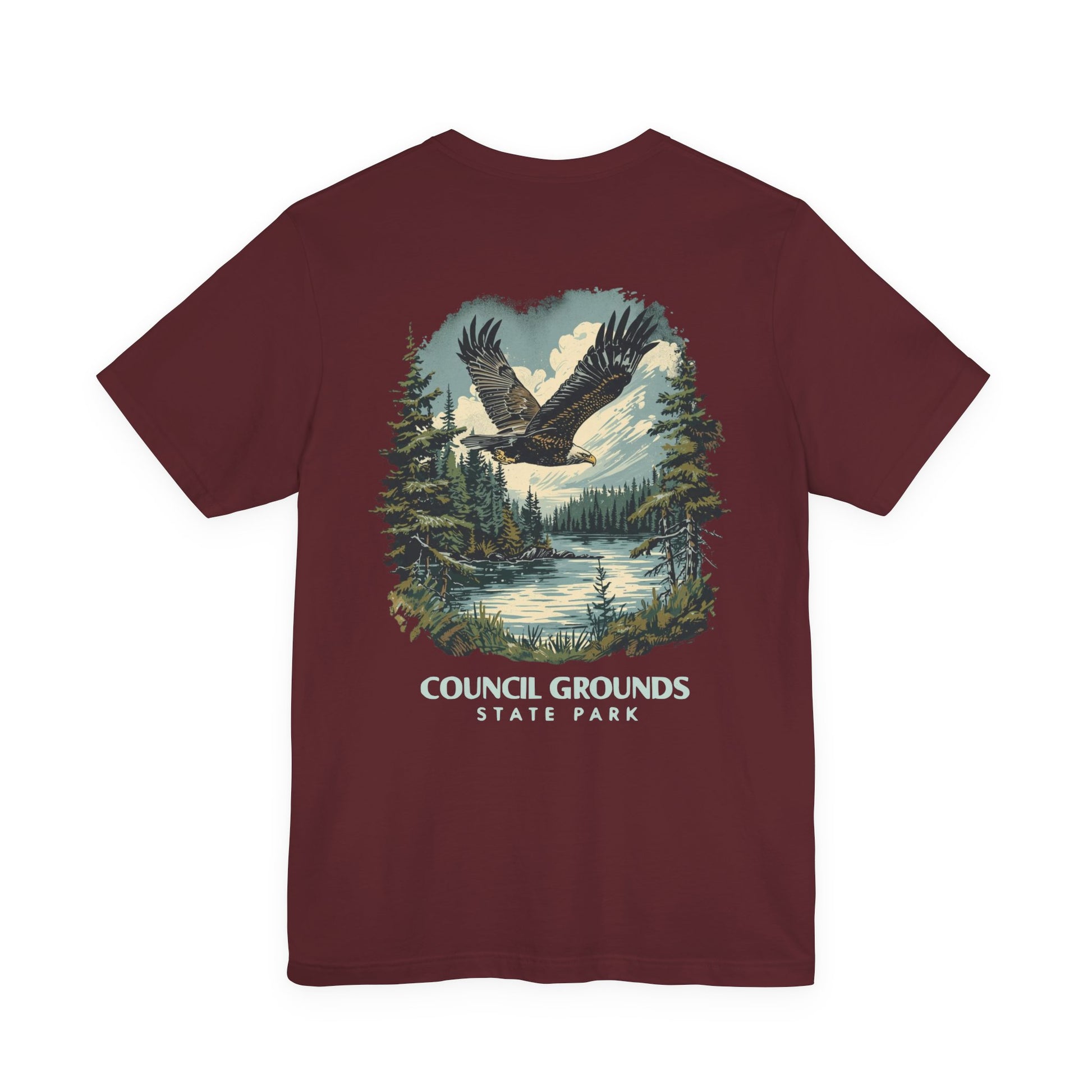 Maroon t-shirt with eagle and forest graphic and 'Council Grounds State Park' text on a white background
