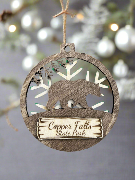 Wood Bear magnet with snowflake background and text "Copper Falls State Park".