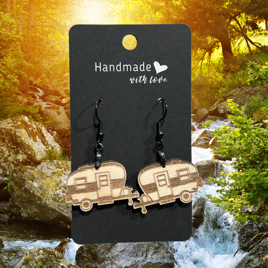 Retro style wood camper earrings.  Photo background: water rushing down a rocky channel through a lush forest.