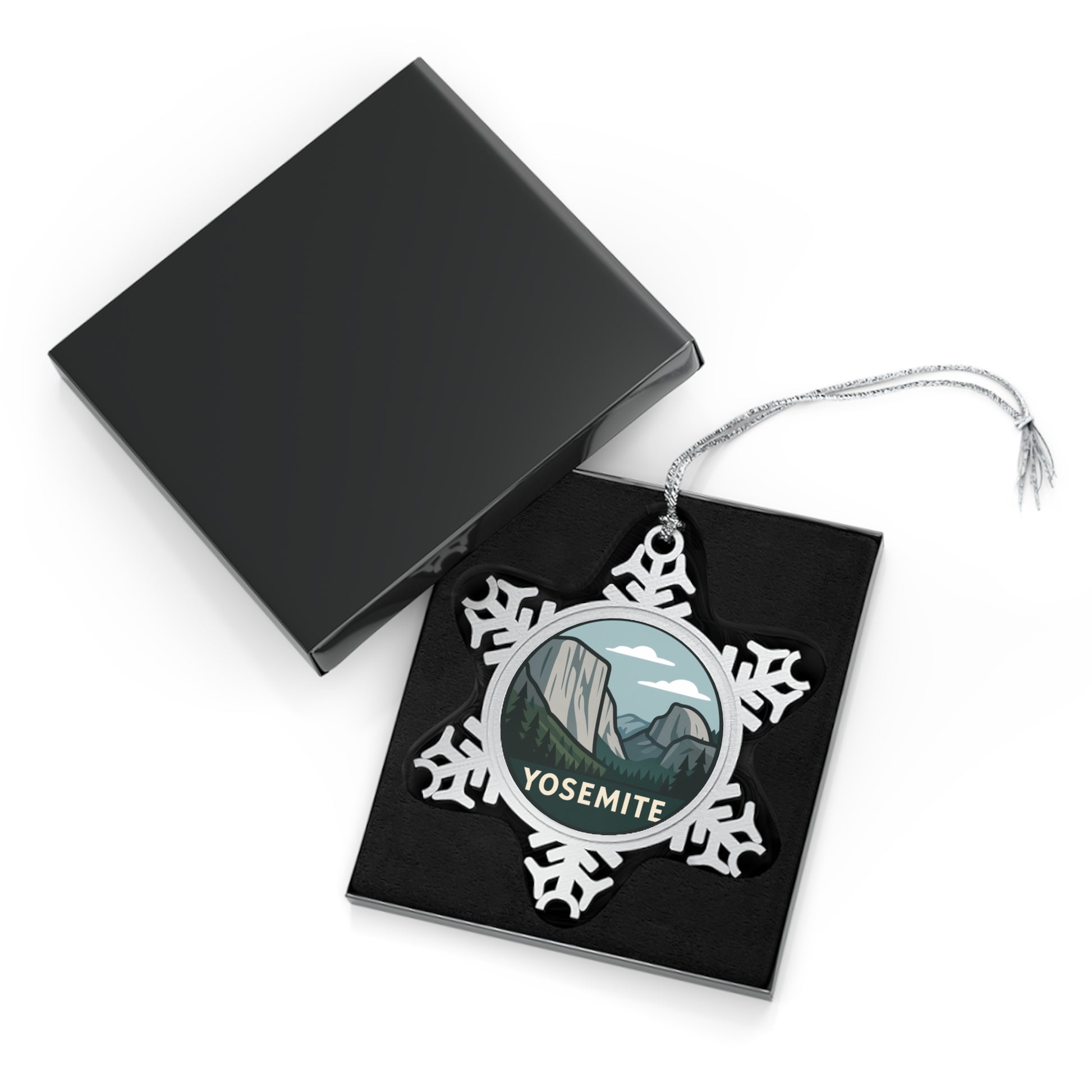 Yosemite-themed snowflake ornament in a black display box with a white background