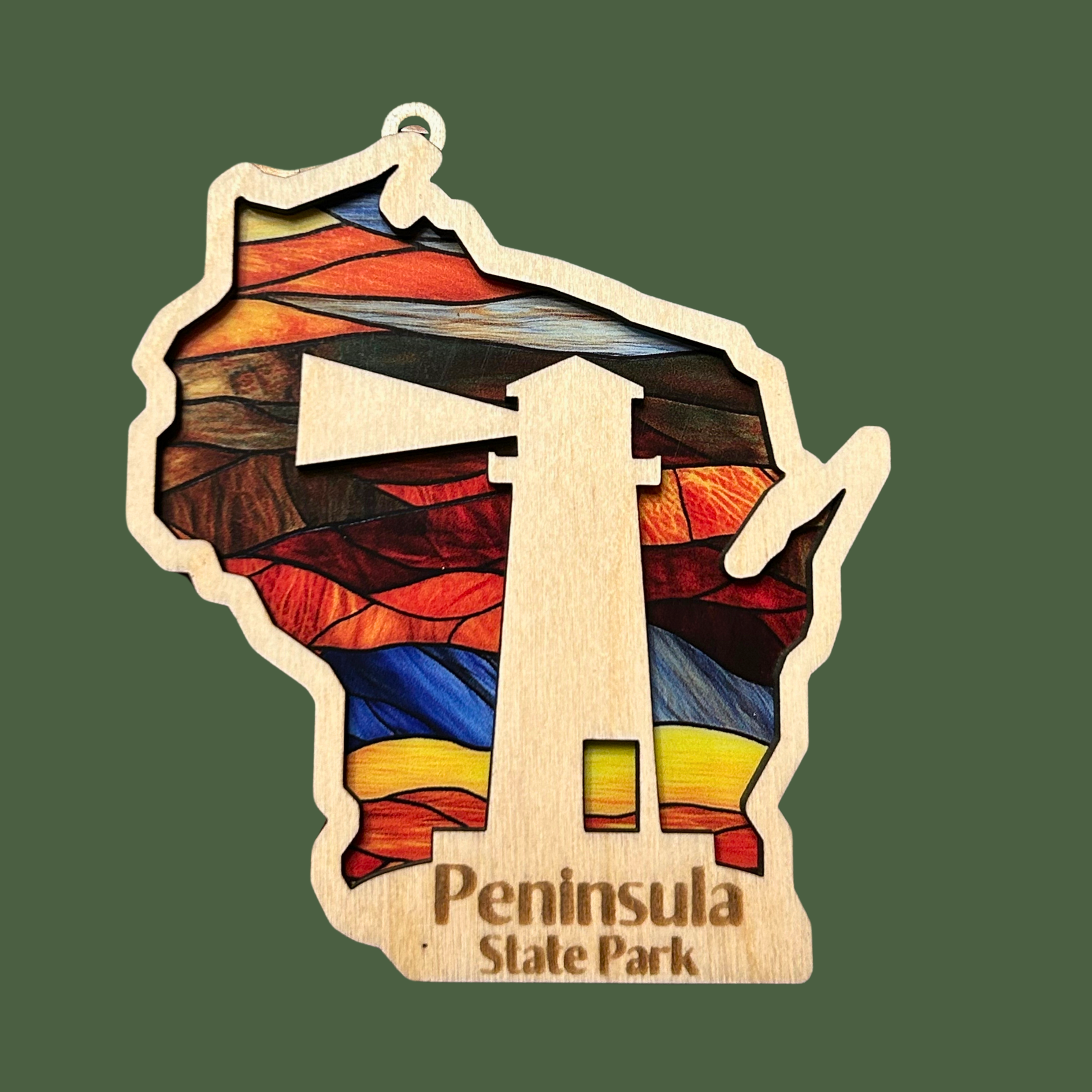 Wood Wisconsin Shaped ornament with a stained glass look and a lighthouse.  Includes the text: Peninsula State Park. Photo Background: green.