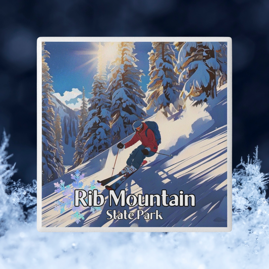Ceramic coaster featuring a skier going down a snowy, wooded slope and the text: Rib Mountain State Park.  Photo Background: Close up view of snowflakes against a dark blue background. 