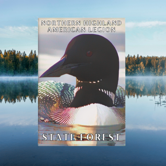 Button magnet featuring a closeup of a loon with vibrant colors and the text “Norther Highland American Legion State Forest”.  Photo Background: calm lake with morning mist. 