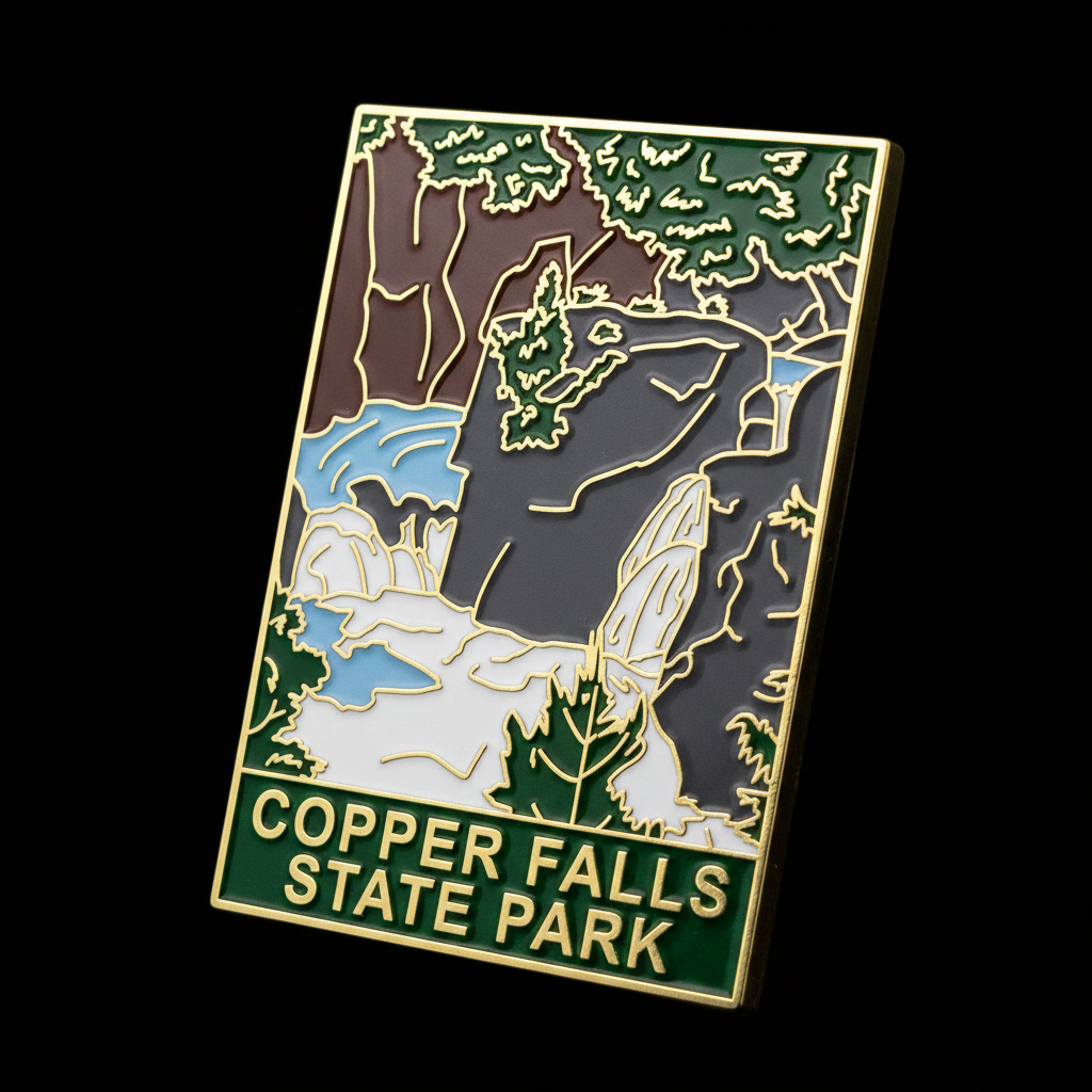 Enamel pin with Copper Falls State Park design on a black background