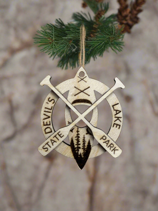 Wood ornament with the text "Devil's Lake State Park" and kayak with crossed paddles. 