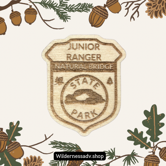 Wood Jr. Ranger badge with the text: Junior Ranger Natural Bridge State Park.  Photo background of leaves and acorns.