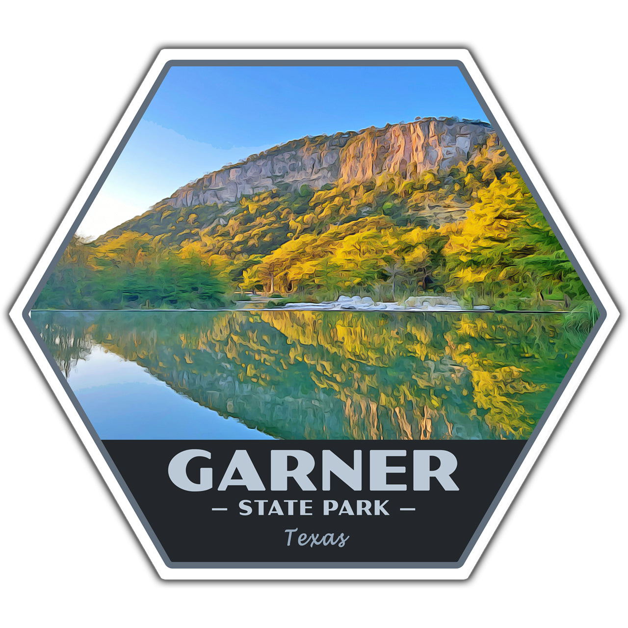A hexagonal sticker or decal featuring a scenic landscape of Garner State Park in Texas, with a rocky hillside, green and yellow trees, a reflective lake, and a dark bottom panel reading “GARNER STATE PARK Texas.”.