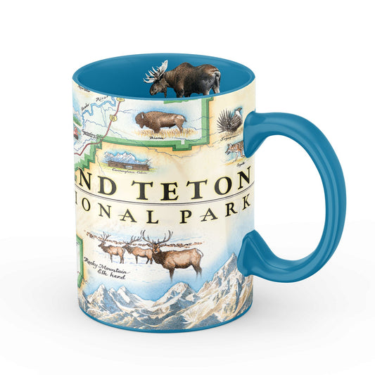 A ceramic mug featuring a colorful illustrated map of Grand Teton National Park with wildlife and mountain scenery, finished with a bright blue handle and interior.