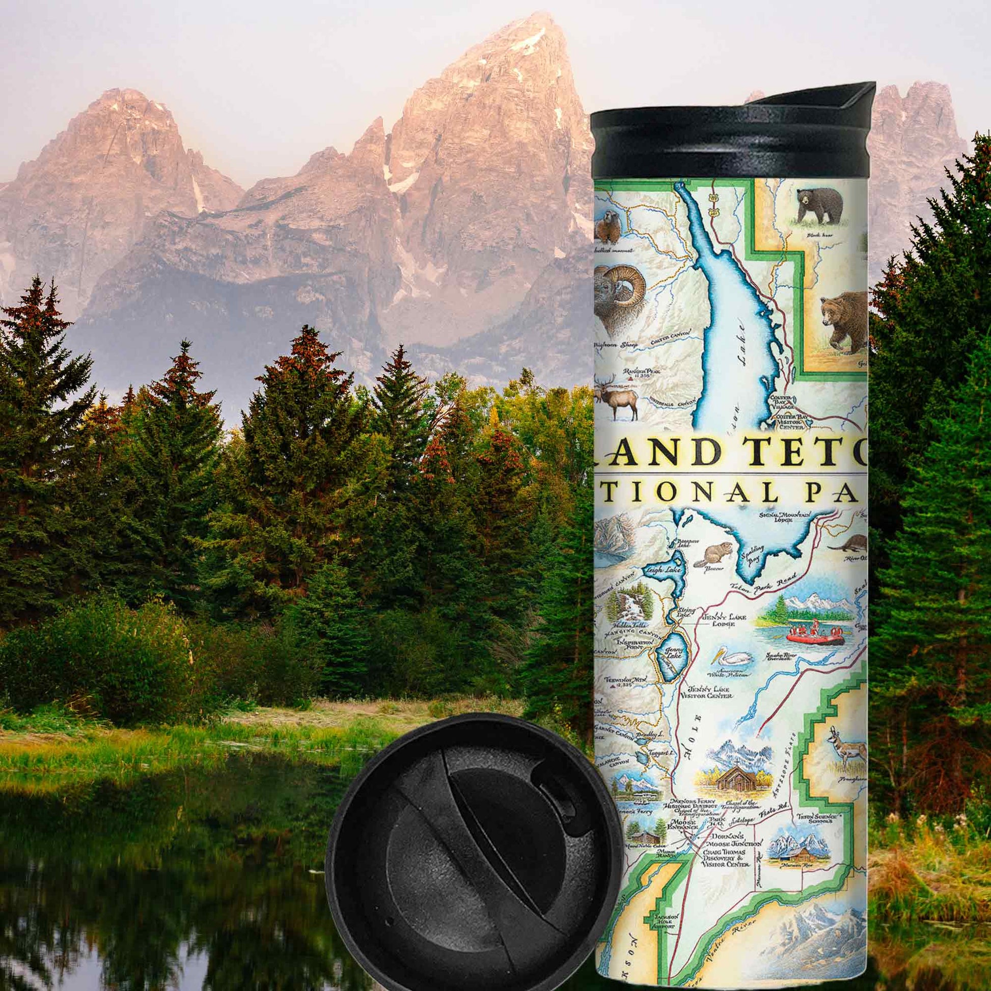Stainless steel water bottle with a map of grand Tetons national Park printed on it displayed against a forest and mountain background