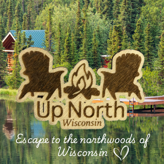 Wood magnet in the shape of two Adirondack chairs and a campfire pictured against a cabin and lake backdrop.