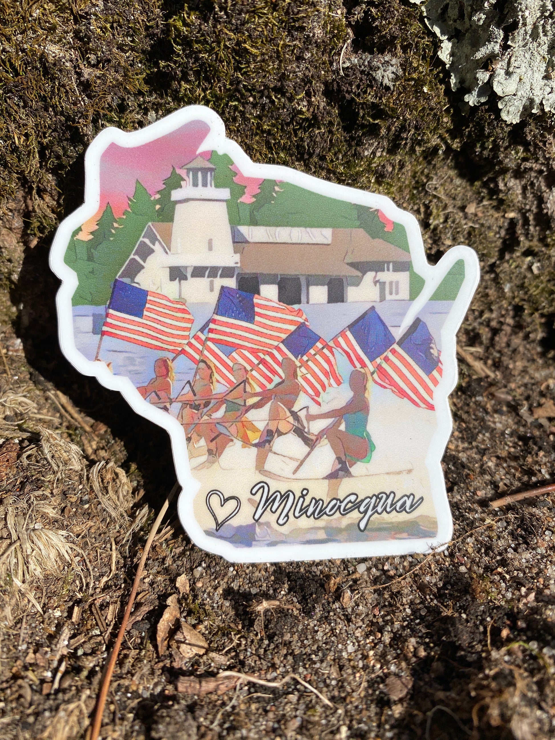 Wisconsin shaped sticker featuring water skiers holding American flags with the iconic Beacons resort. Photo Background: dirt and grass.