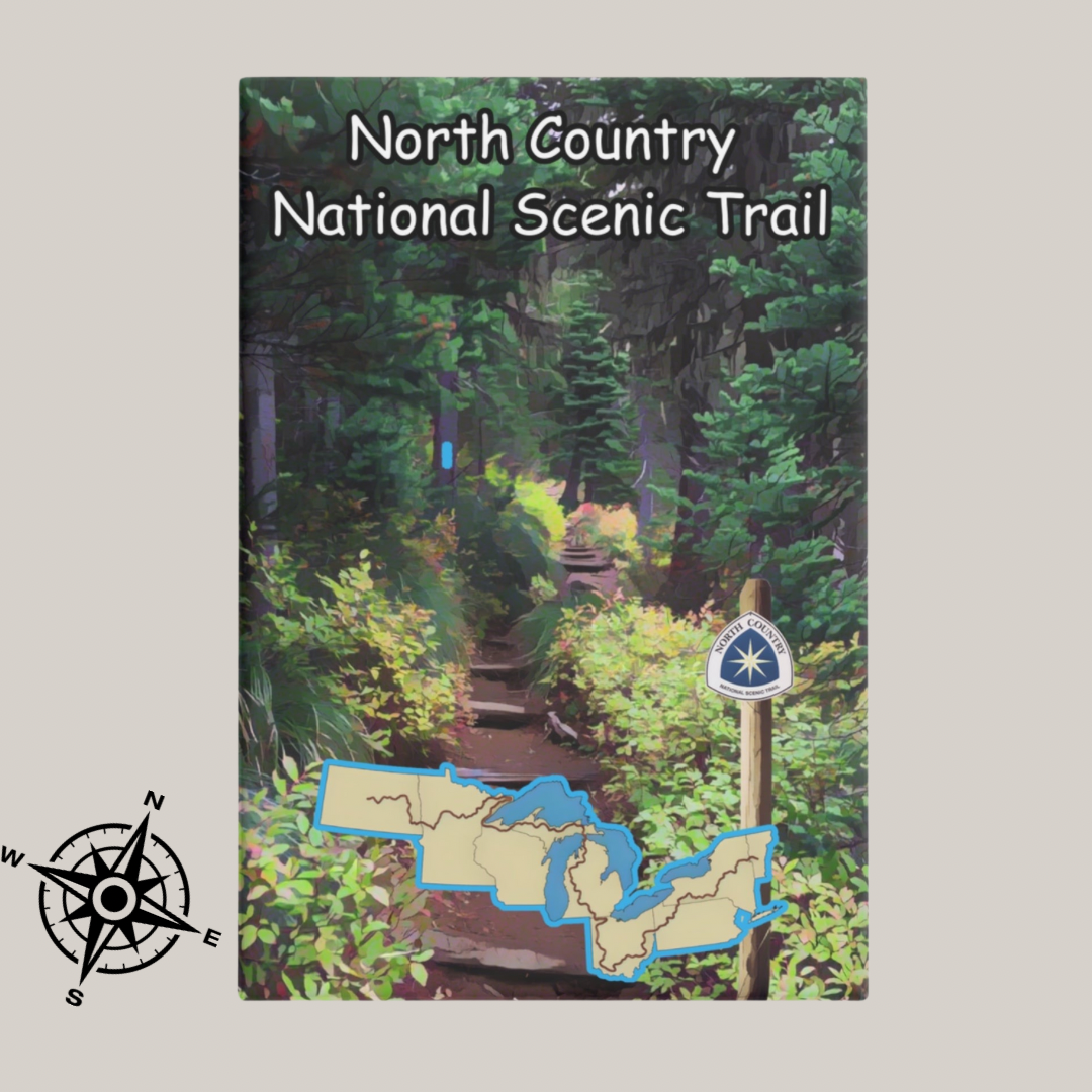 Metal button magnet depicting a narrow hiking trail through the woods and a map of the North Country Trail.