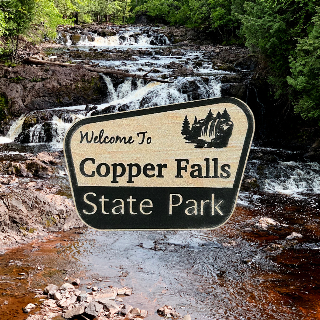 Wood grain acrylic magnet with “welcome to Copper Falls State Park” and waterfall icon.  Photo background: Tyler Forks cascades.
