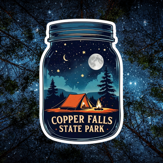 A mason jar shaped decal with an image of a tent set up in the woods under a full moon and starry sky and the text Copper Falls State Park.  Photo background: looking up through pine trees at a star filled sky.