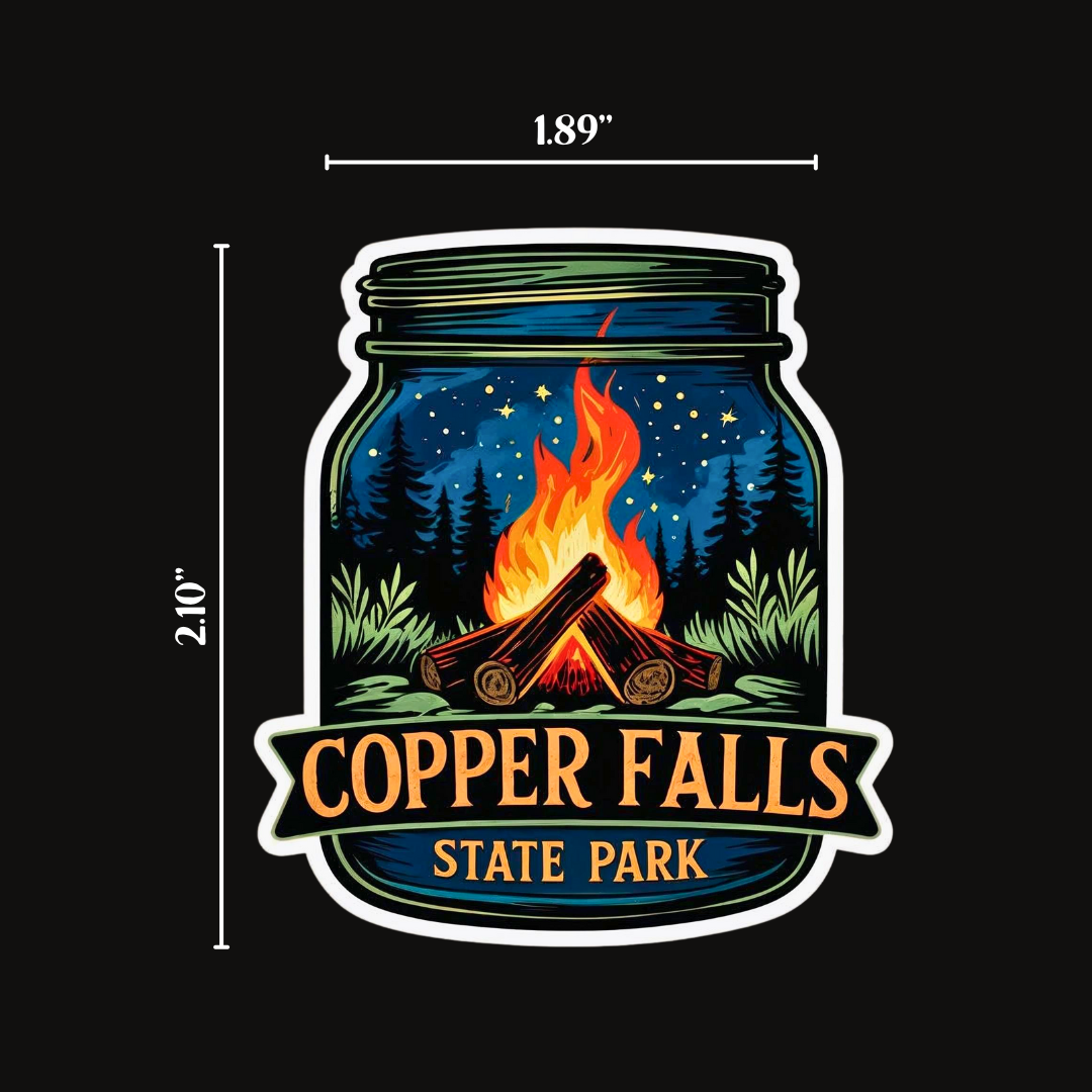 Mason jar shaped sticker with a starry night and campfire scene and the text Copper Falls State Park.  Photo background: solid back with size indicators to show sticker dimensions.