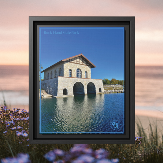 Black Framed canvas print featuring the iconic stone boathouse at Rock Island State park set against a clear blue sky and blue water.  Photo background, vibrant, purple blue flowers, along the shore of a lake at sunrise.
