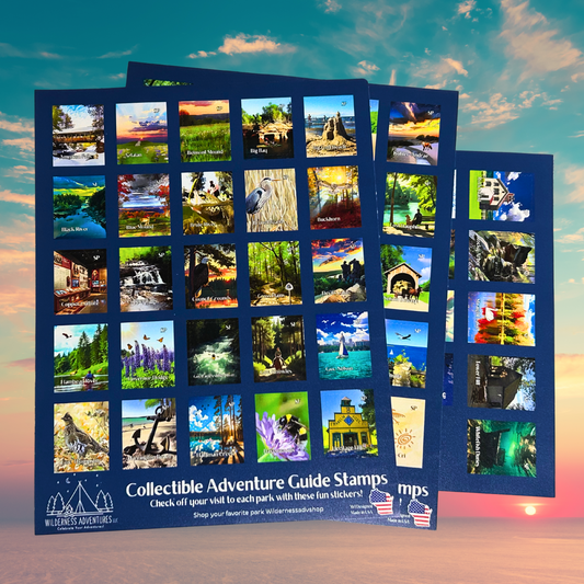 Three dark blue sticker sheets of stamp shaped decals for the Wisconsin State Parks, Forests, and Trails Adventure Guide.  Photo background: colorful sunset over a vast body of water.