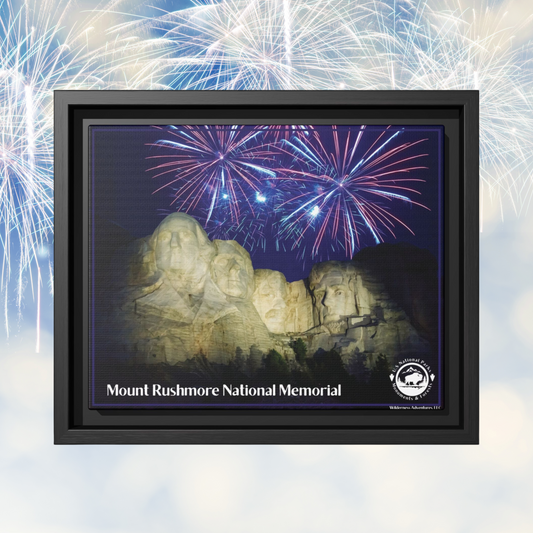 Black Framed canvas print featuring Mount Rushmore at night with a patriotic fireworks display in the background.  Photo background: fireworks against a blue sky.