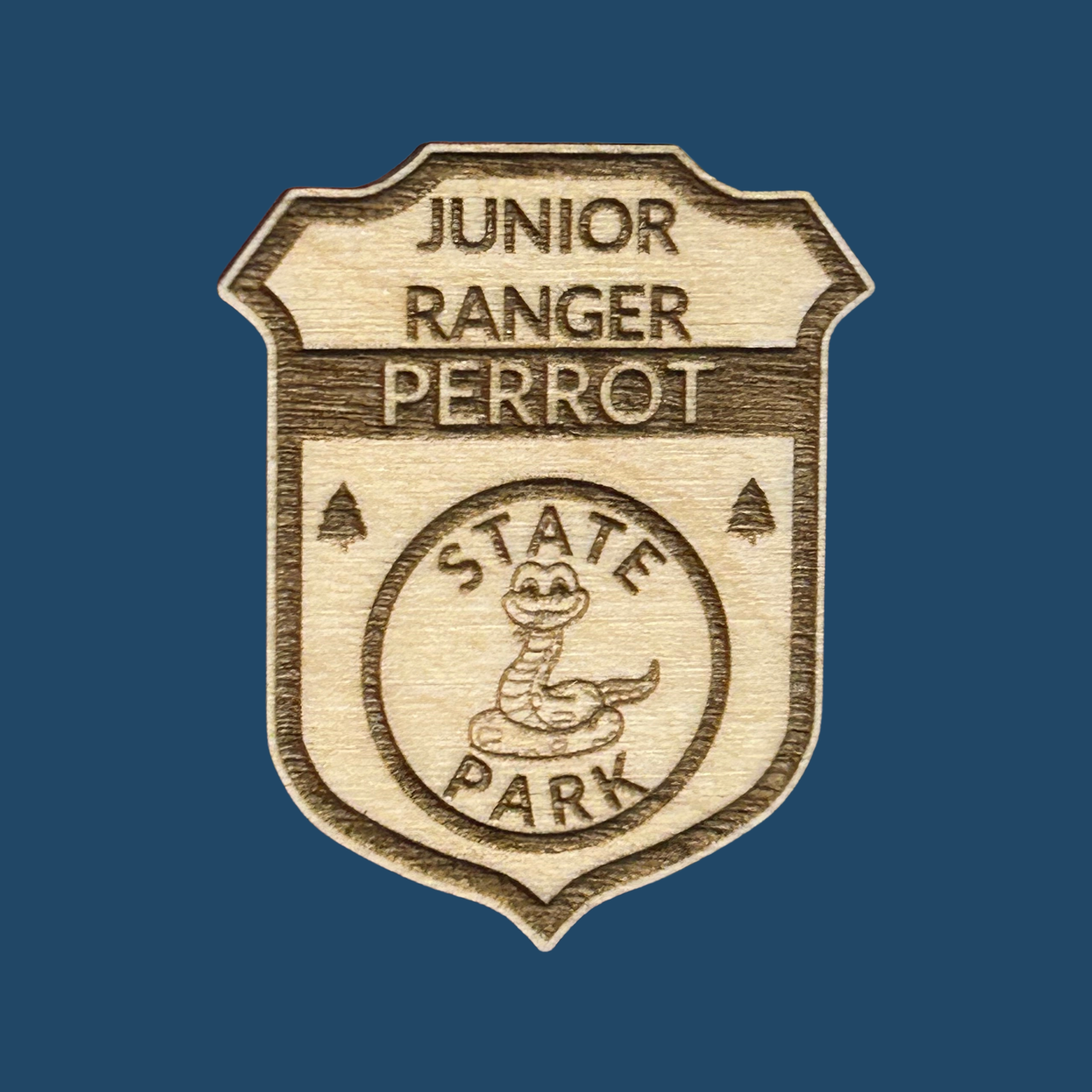 Wooden badge with 'Junior Ranger Perrot State Park' text on a blue background