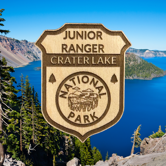 Junior Ranger badge for Crater Lake National Park with a scenic background of the lake and mountains.