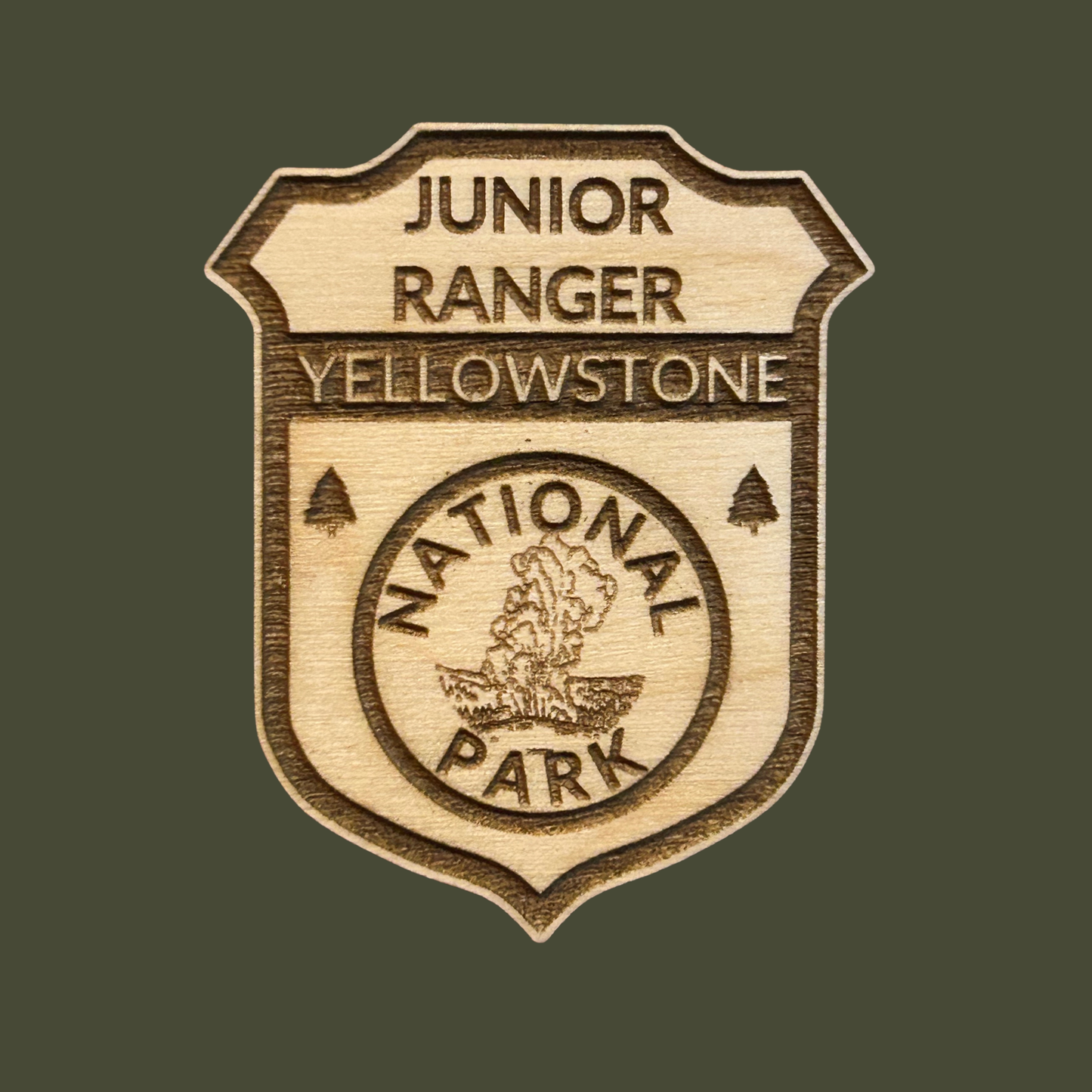 Wood Yellowstone National Park Jr Ranger badge with a dark green background.