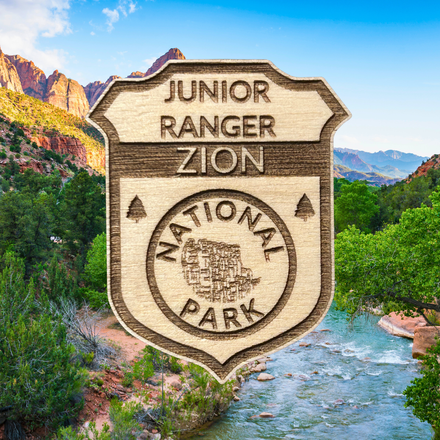 Wood Junior Ranger Zion National Park badge with a scenic background of mountains and river.