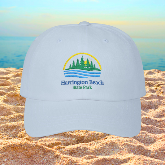 Light blue cap with Harrington Beach State Park logo on a sandy beach