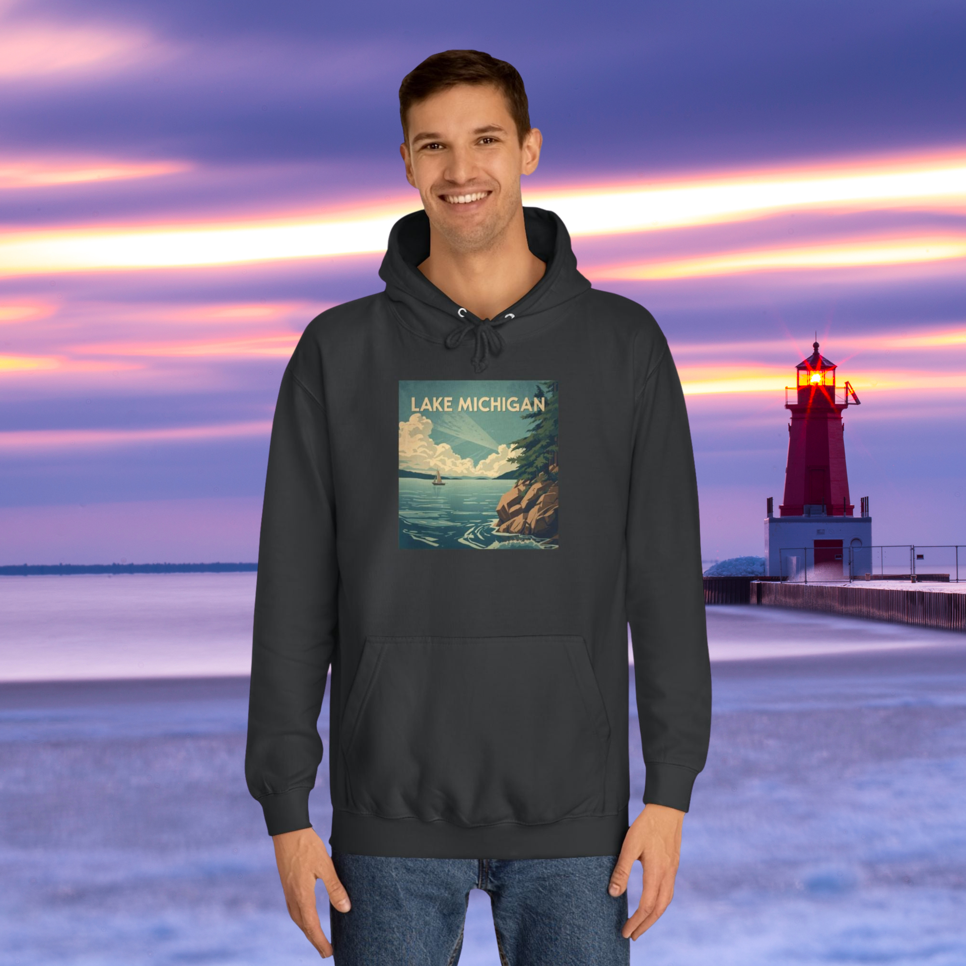 Person wearing a Jet Black hoodie with a Lake Michigan design in front of a lighthouse at sunset.