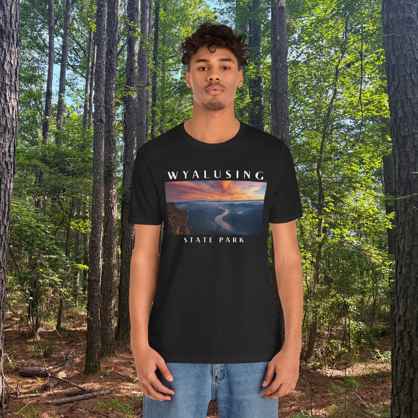 Person wearing a black t-shirt with 'Wyalusing State Park' design in a forest setting