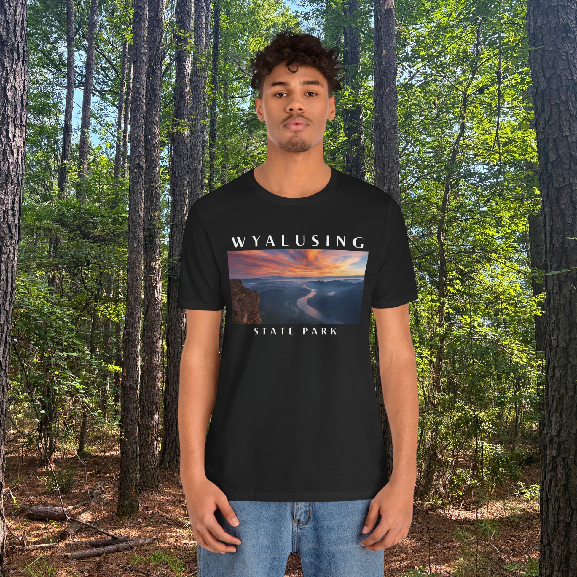 Person wearing a black t-shirt with 'Wyalusing State Park' design in a forest setting