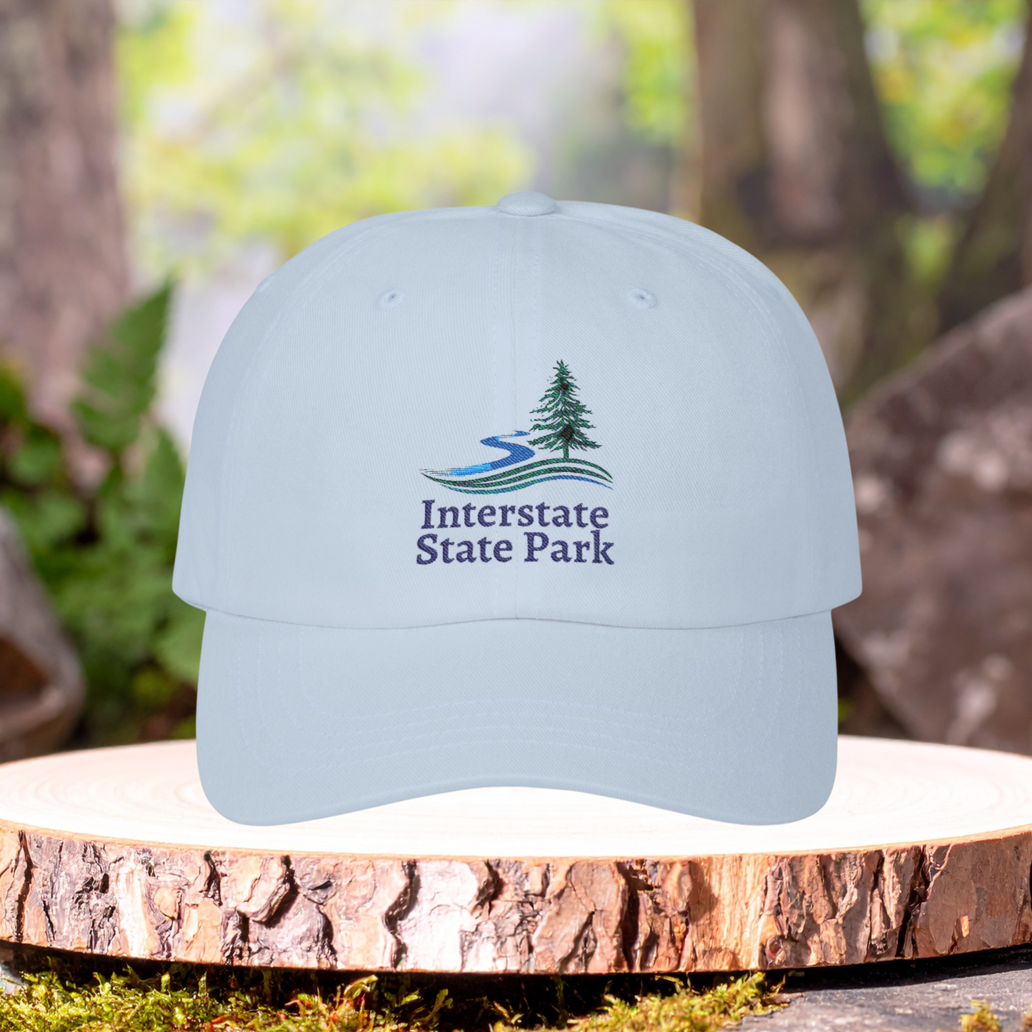 Light blue cap with 'Interstate State Park' logo on a wooden surface with a natural background