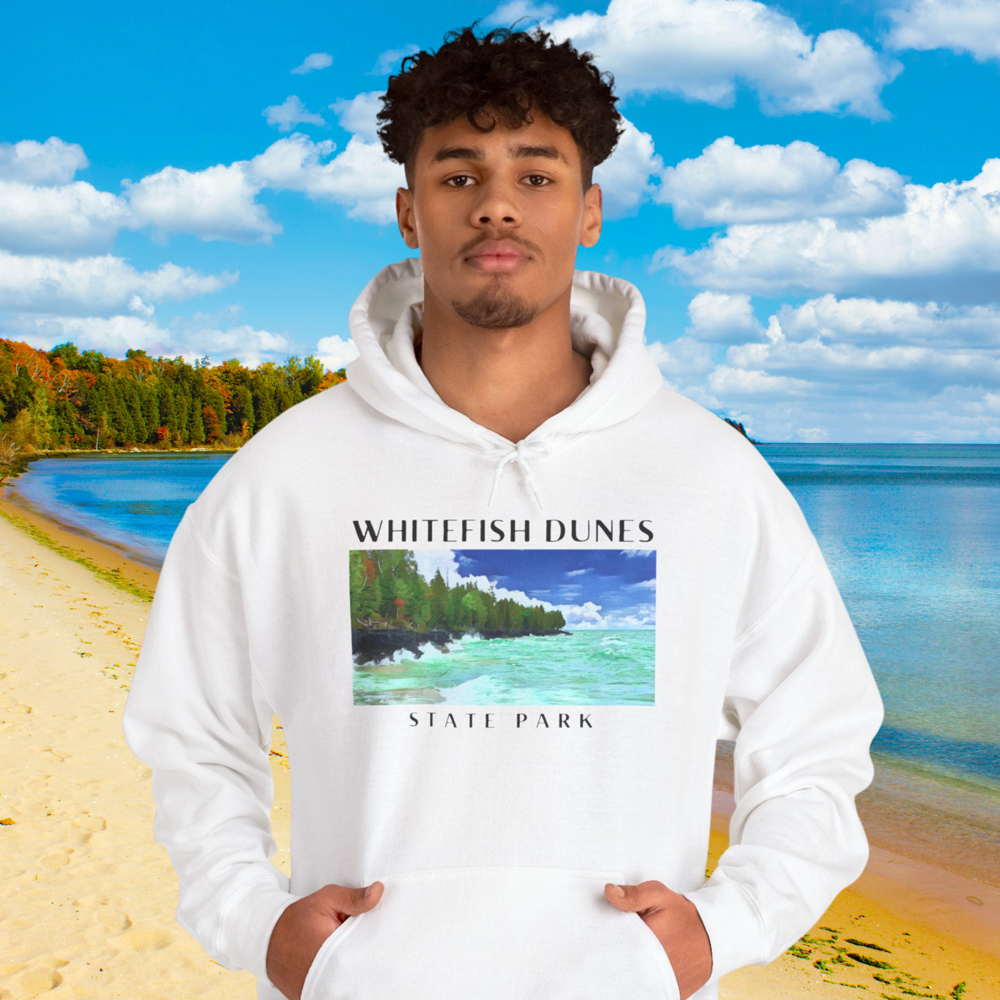 Person wearing a white hoodie with Whitefish Dunes State Park design against a scenic background